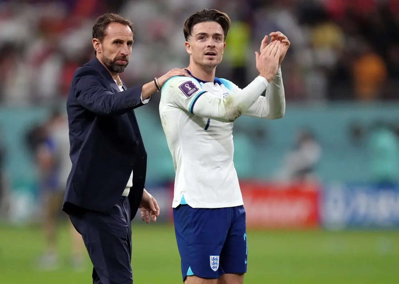 Jack Grealish, right, applauds the England fans as Gareth Southgate pats him on the back during the 2022 World Cup