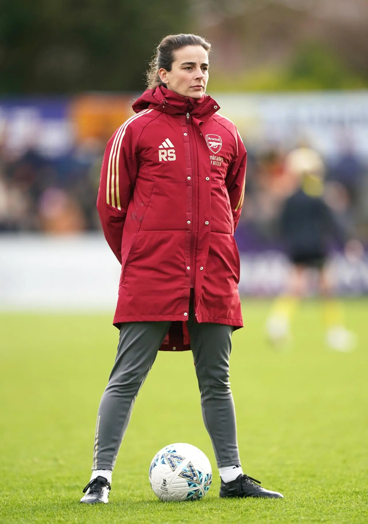 Renee Slegers stands with a football