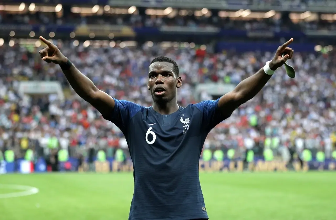 France midfielder Paul Pogba celebrates with both arms aloft