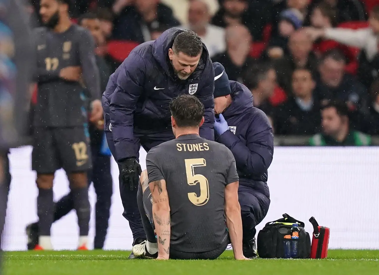 England’s John Stones receives treatment for an injury during a friendly against Belgium