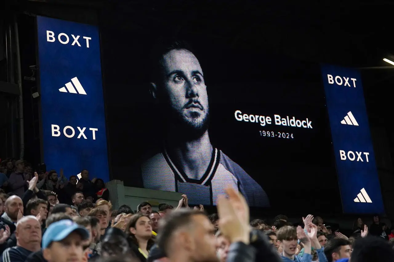 A screen showing an image of George Baldock