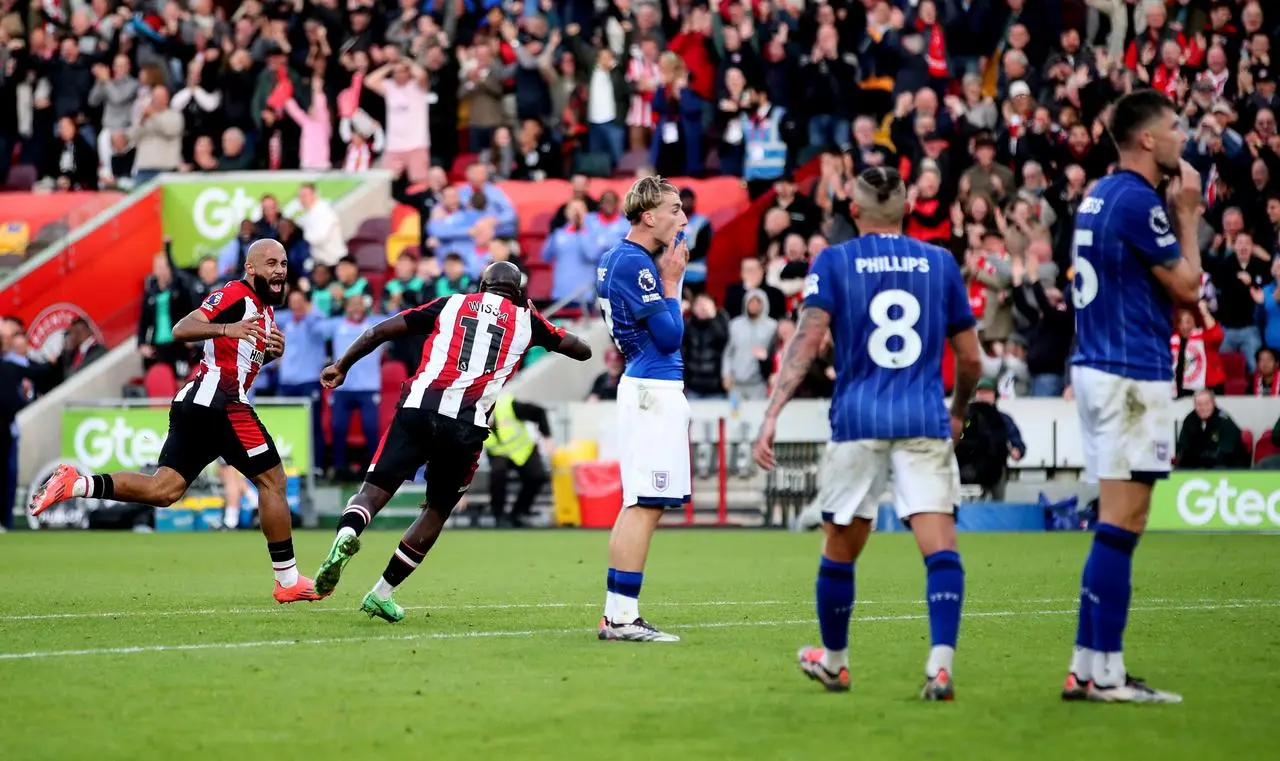 Brentford’s Bryan Mbeumo, left, celebrates scoring his side’s fourth goal as Ipswich's Jack Clarke, Kalvin Phillips and Cameron Burgess look despondent