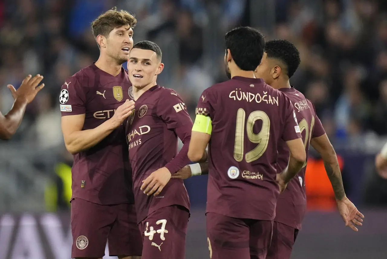 Phil Foden, centre left, celebrates his goal with, from left, John Stones, Ilkay Gundogan and Savinho