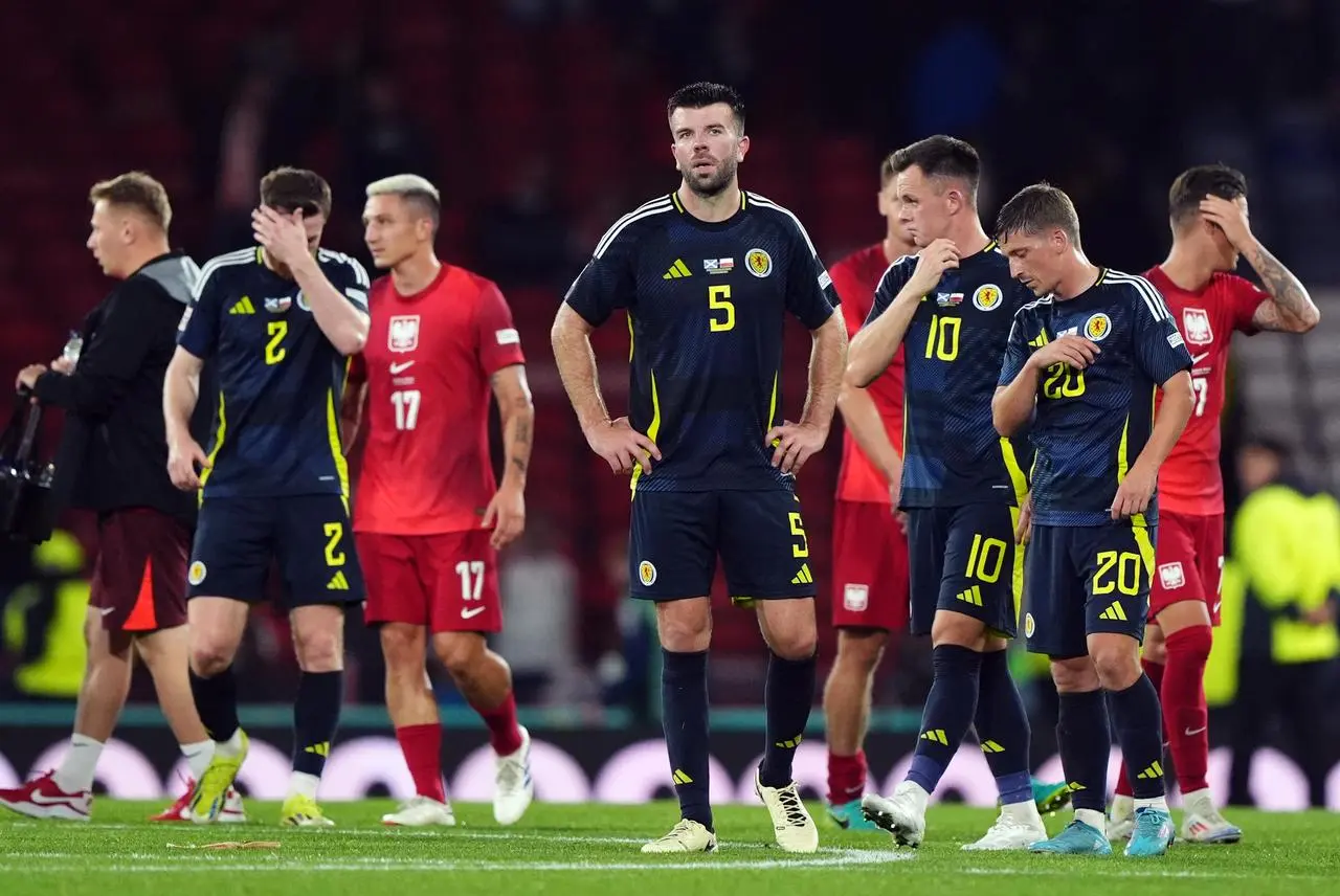 Scotland’s Grant Hanley (right) stands dejected