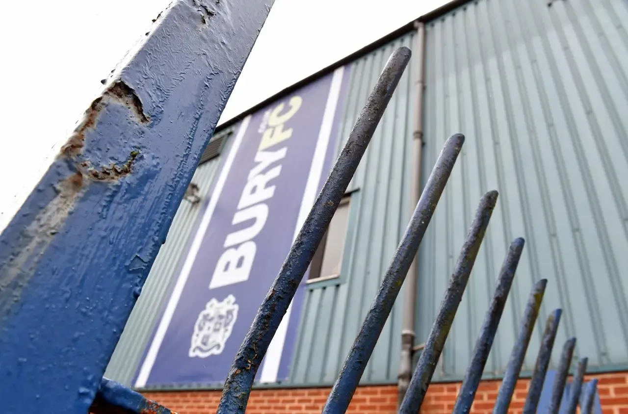 Photo of gates outside Bury's Gigg Lane ground