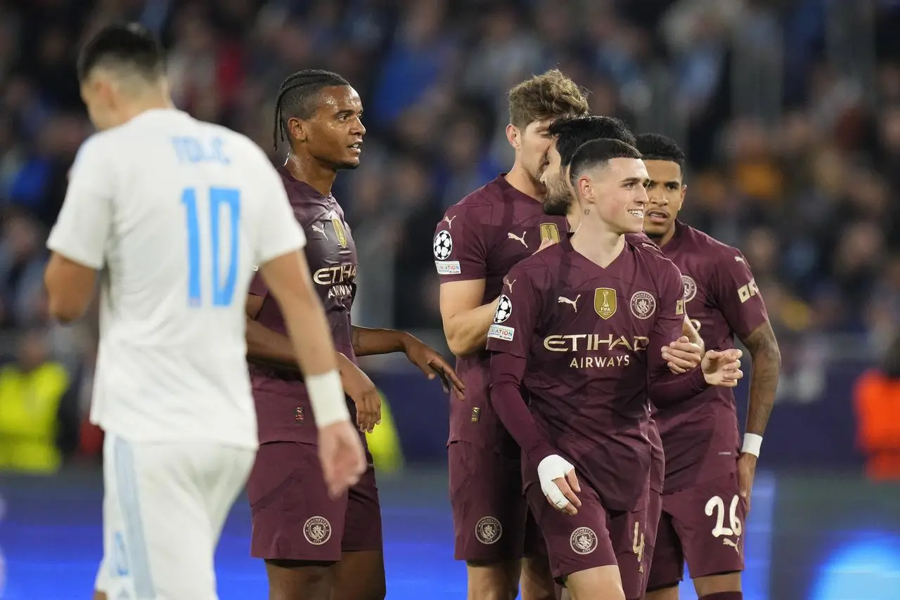 Phil Foden, right, celebrates his goal