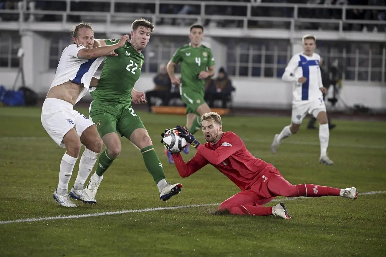 Nathan Collins shields blocks Finland striker Joel Pohjanpalo as Ireland goalkeeper Caoimhin Kelleher grabs the ball