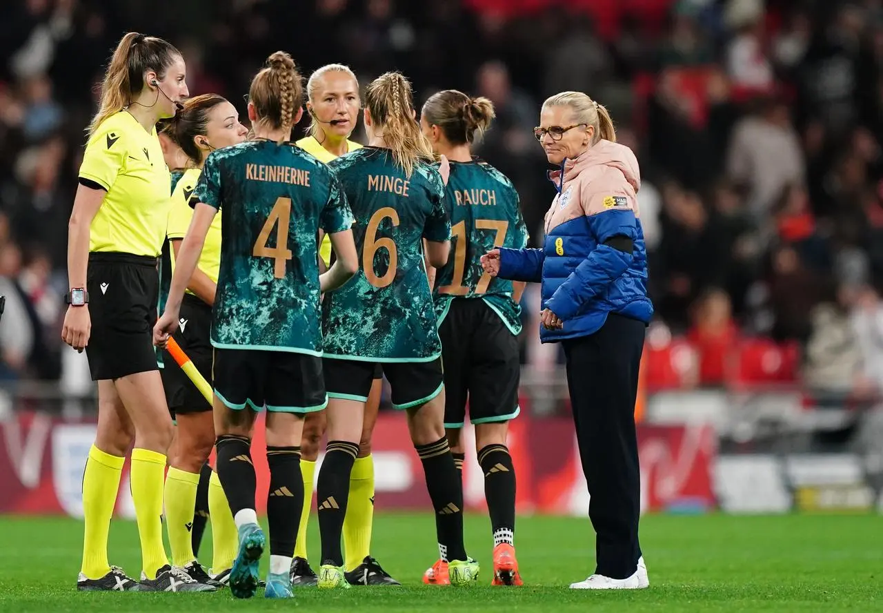 England manager Sarina Wiegman, right, congratulates the Germany players after their win at Wembley