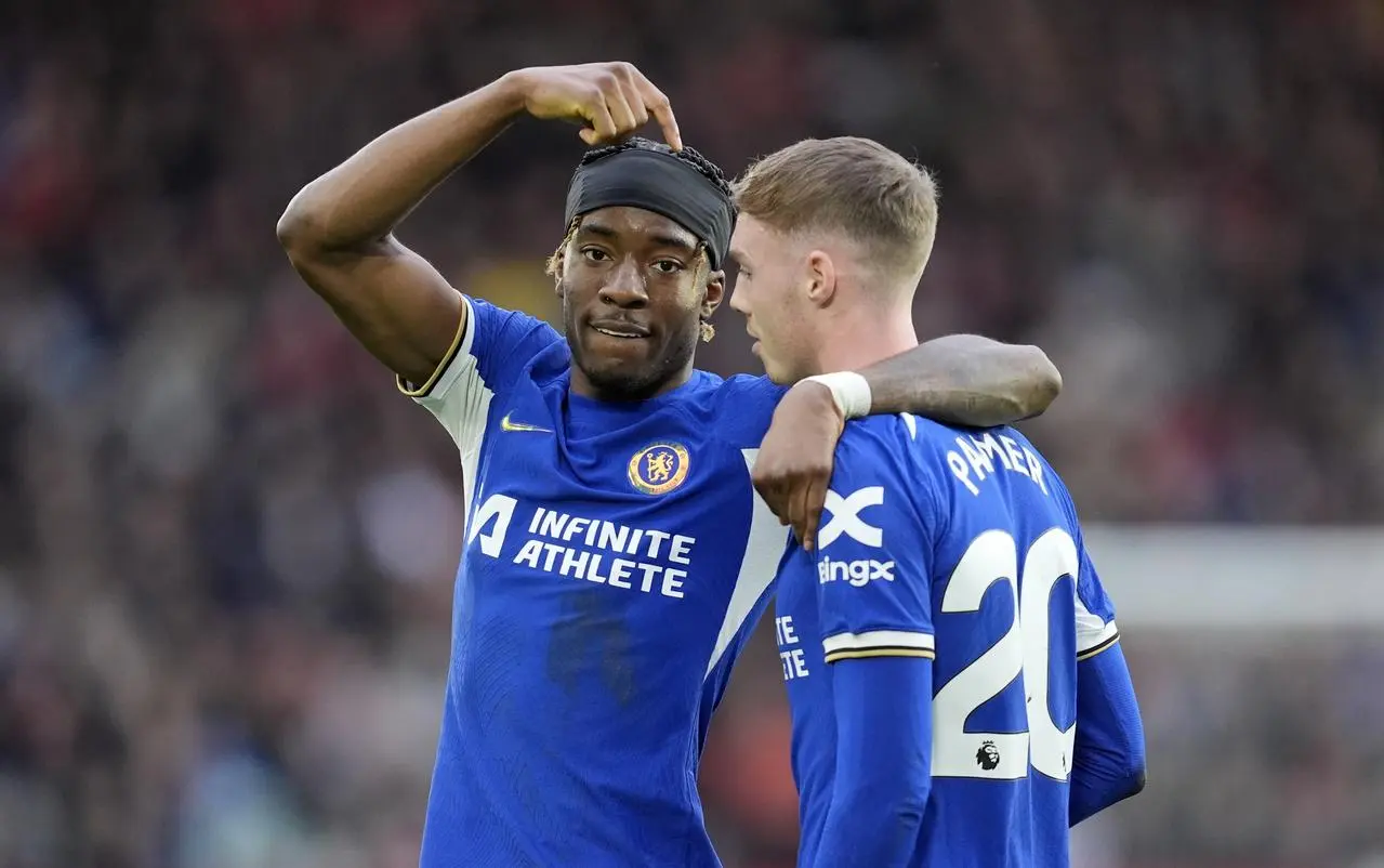 Noni Madueke, left, points to give the credit to Cole Palmer after scoring for Chelsea against Sheffield United