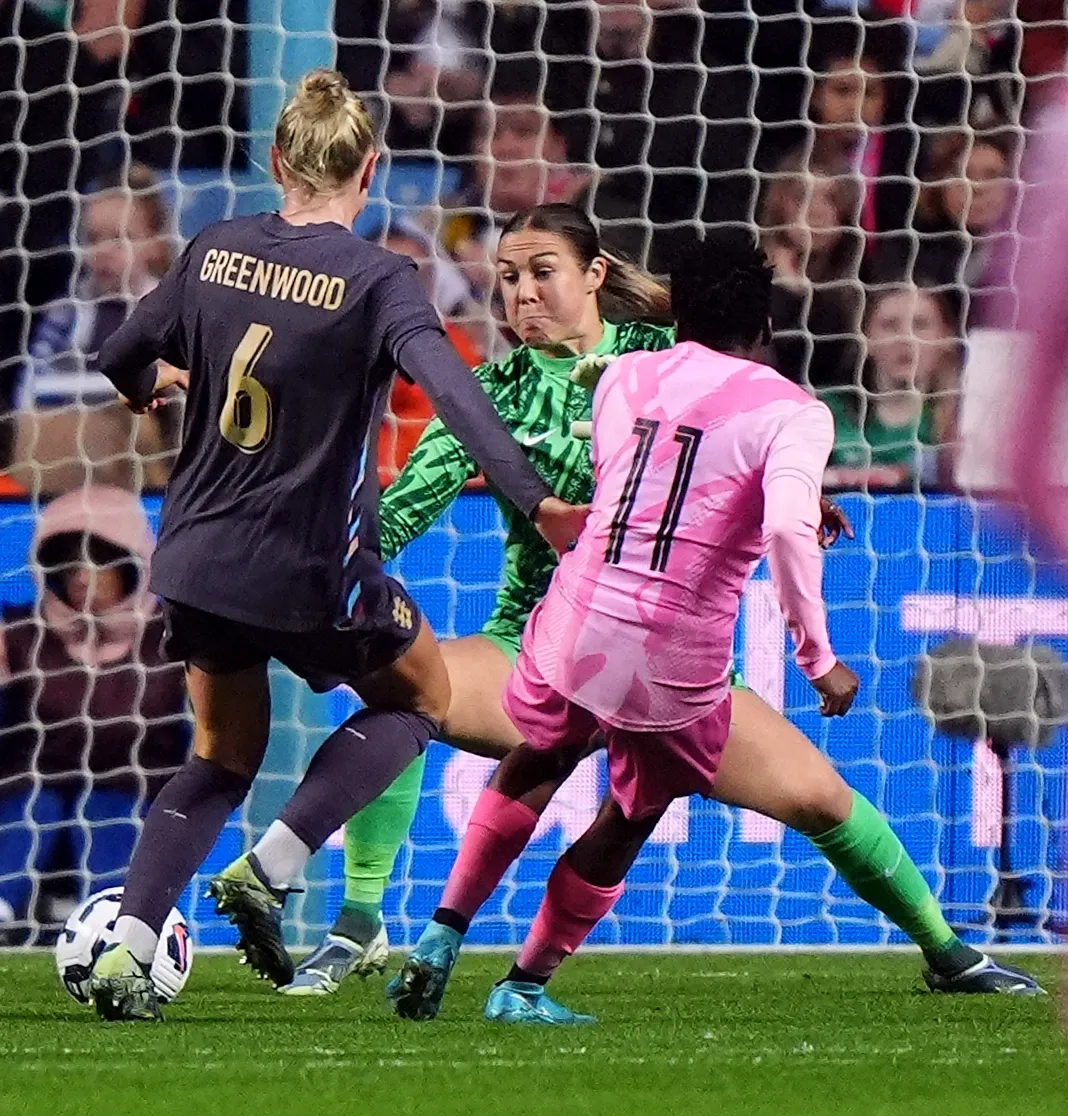 South Africa's Thembi Kgatlana, right, finishes past England goalkeeper Mary Earps under pressure from Alex Greenwood, left