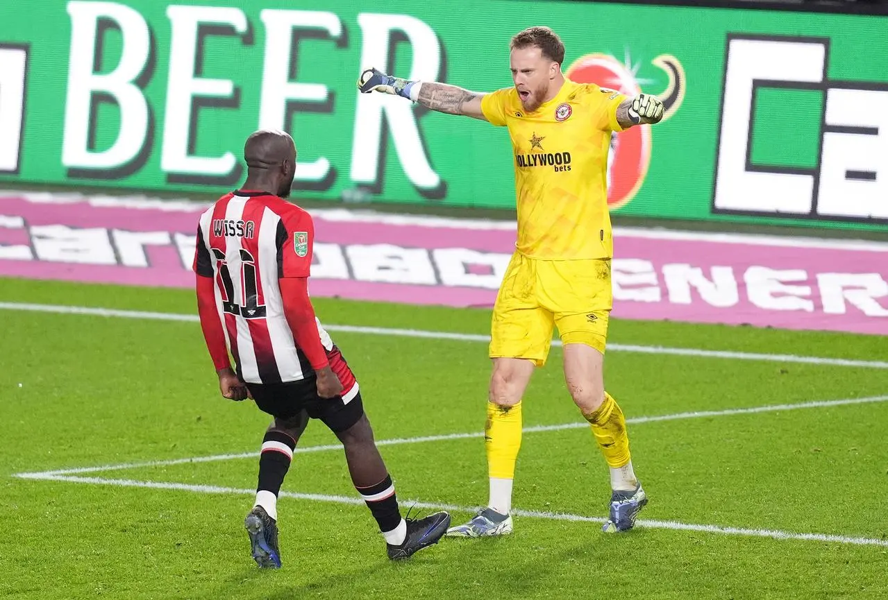 Mark Flekken, right, celebrates his decisive save with team-mate Yoane Wissa 