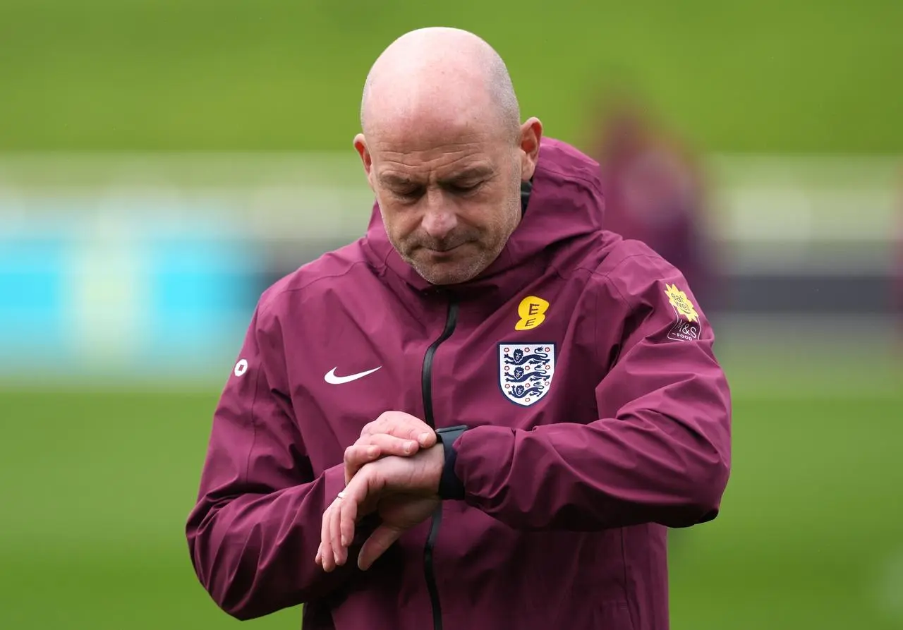 England interim manager Lee Carsley checks his watch during a training session at St George’s Park