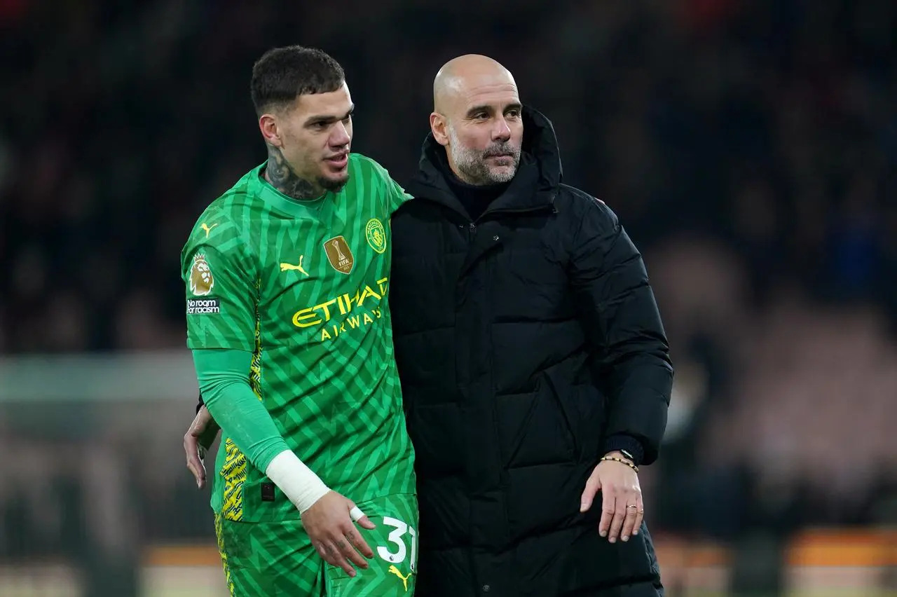 Manchester City goalkeeper Ederson embraces manager Pep Guardiola after a game