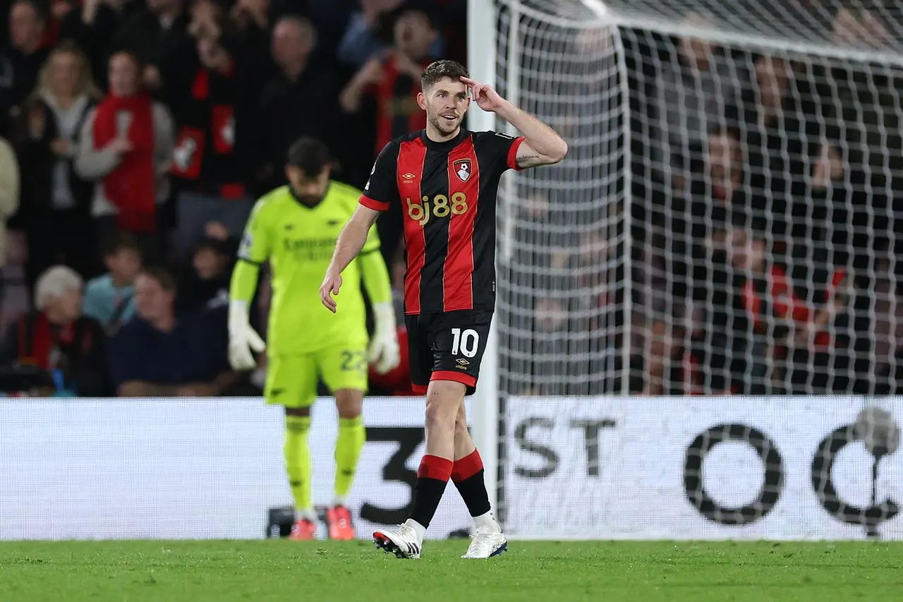 Bournemouth midfielder Ryan Christie puts his hand to his head to salute after scoring against Arsenal