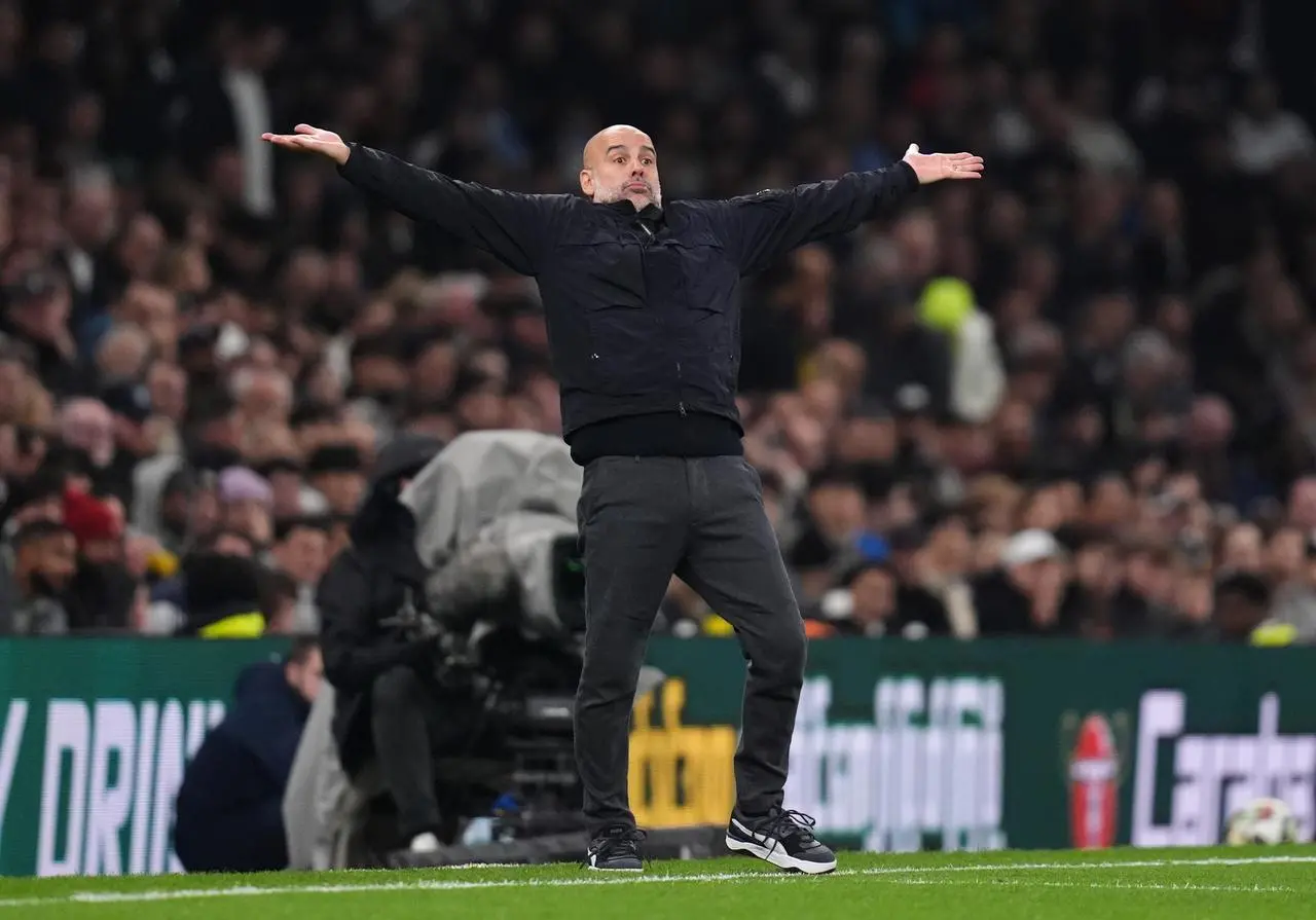 Manchester City manager Pep Guardiola gestures with his arms spread wide during the Carabao Cup loss to Tottenham