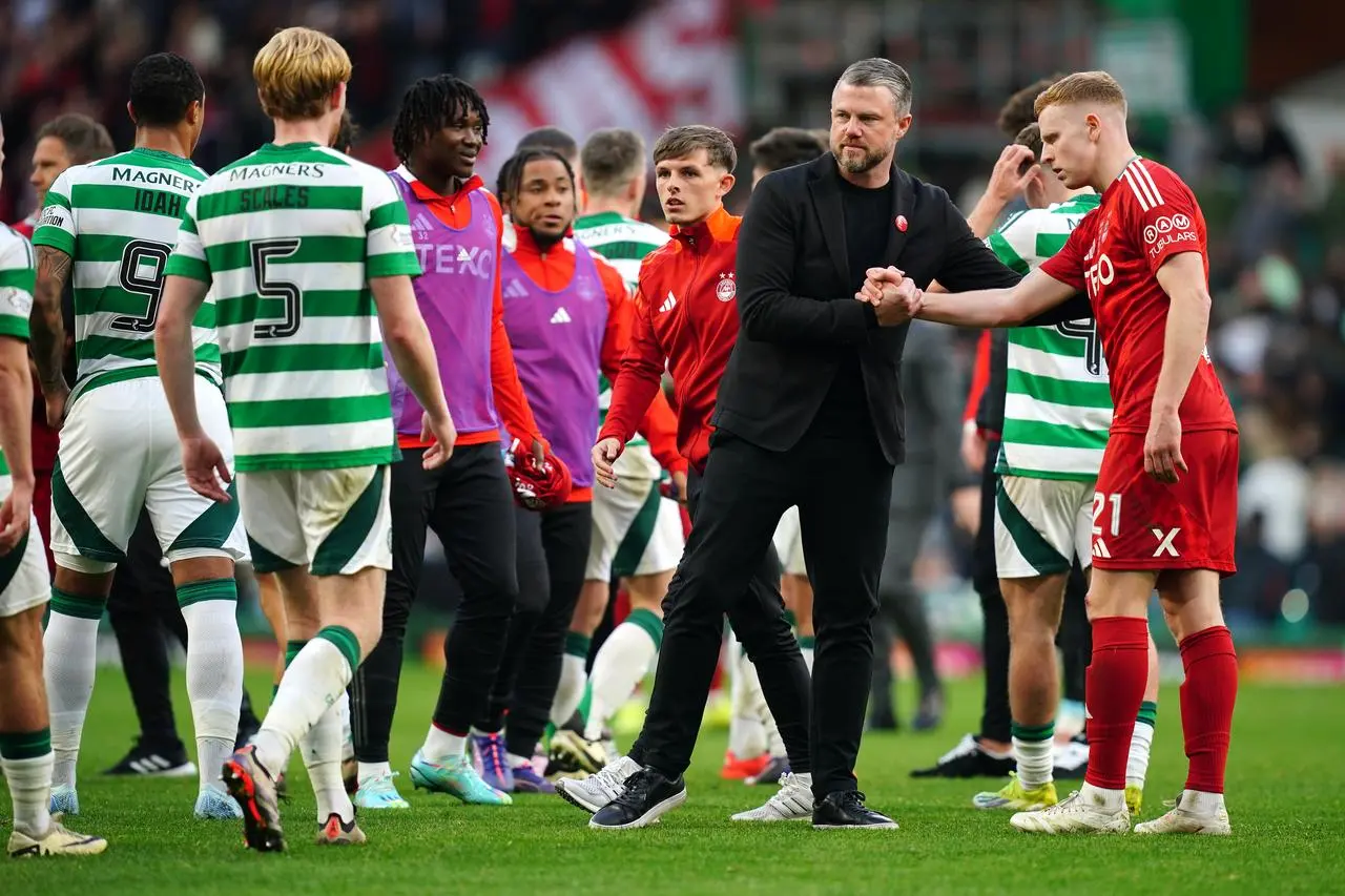 Aberdeen manager Jimmy Thelin shakes hands with Gavin Molloy