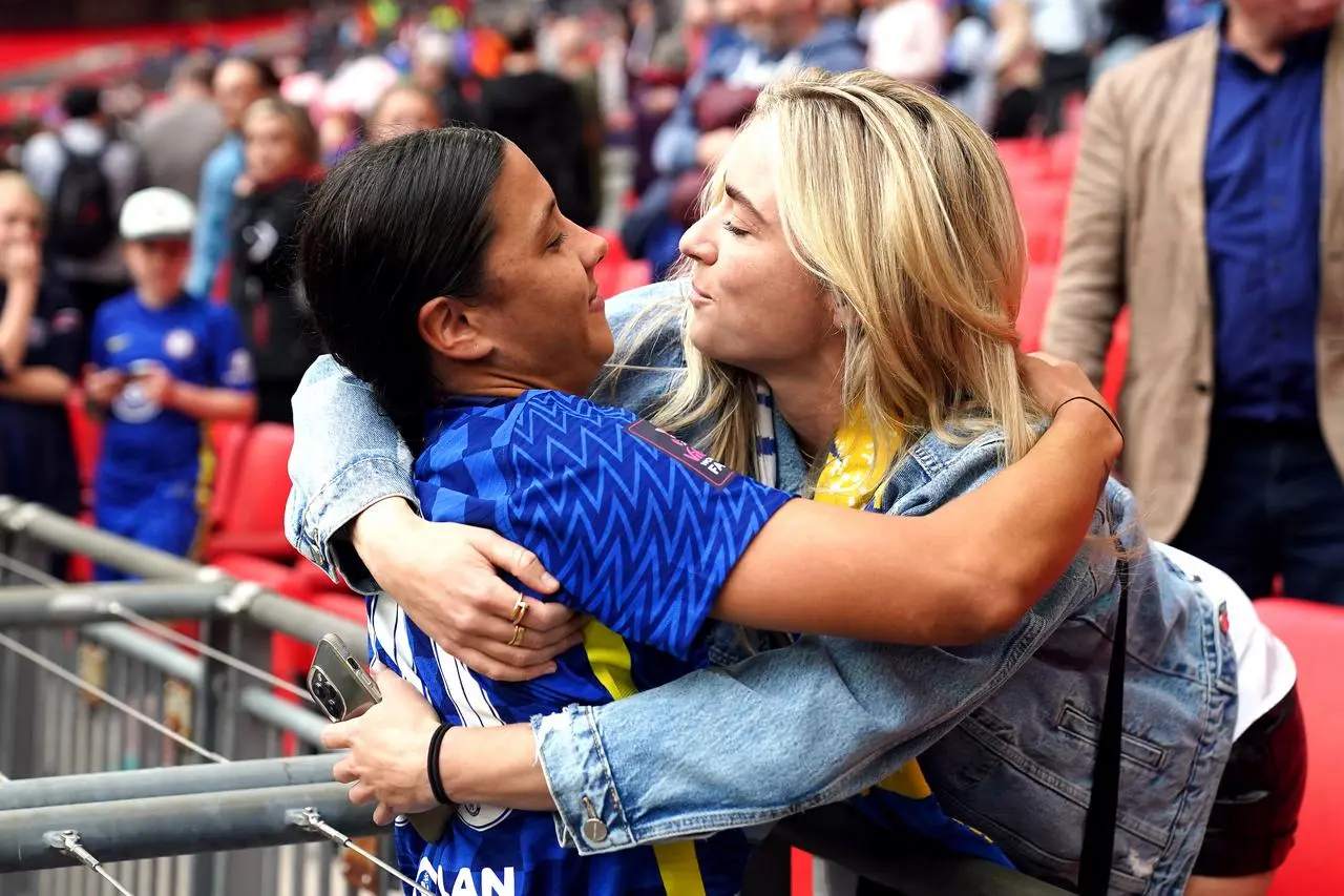 Sam Kerr, left, hugs Kristie Mewis