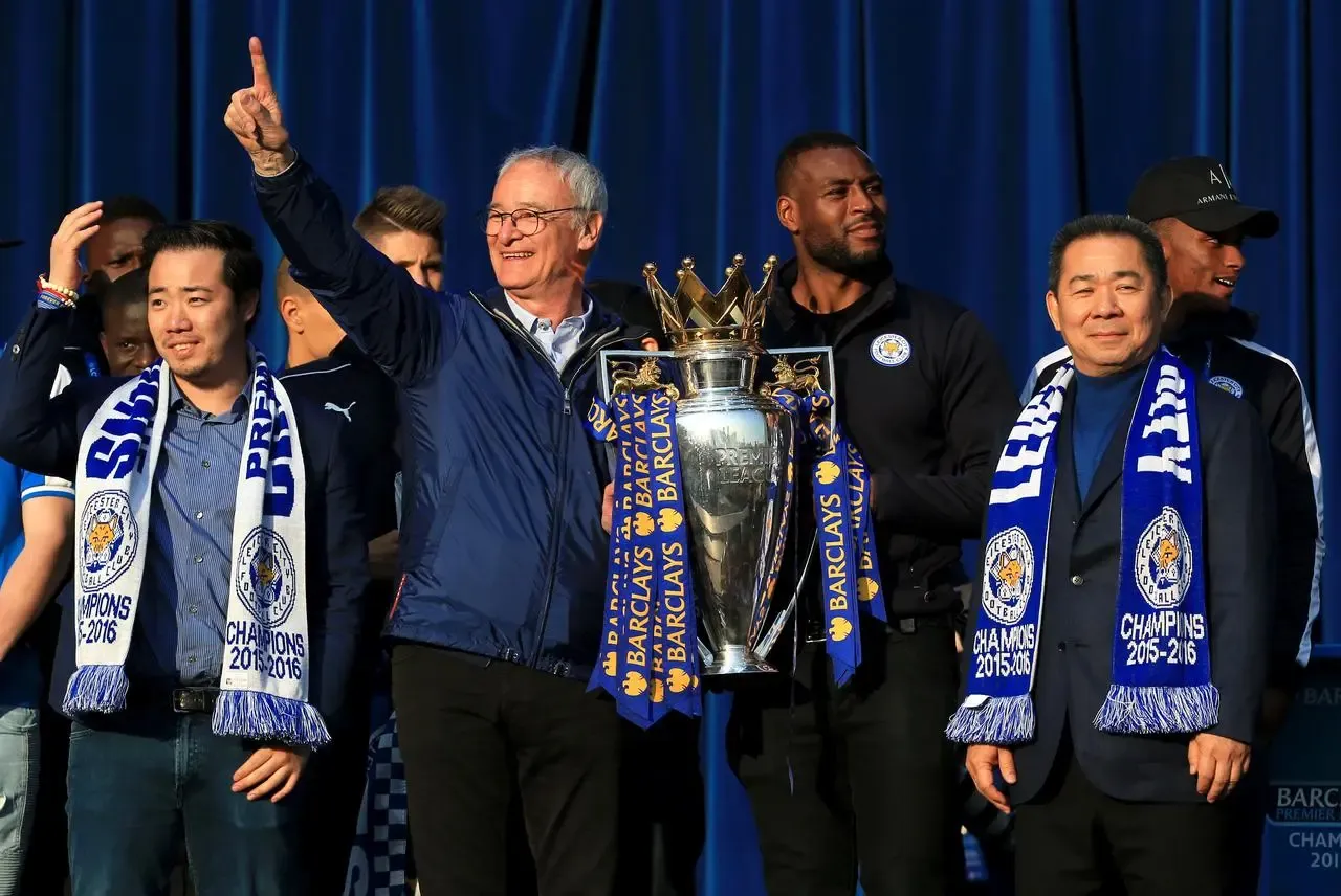 Claudio Ranieri poses with the Premier League trophy