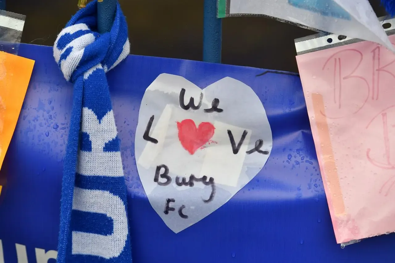 Messages from supporters are placed on a fence outside Gigg Lane stadium, Bury.