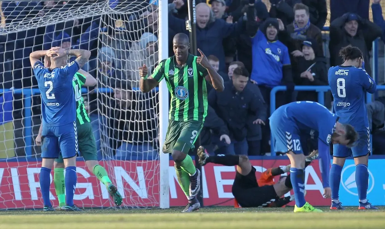 AFC Wimbledon’s Tom Elliott celebrates scoring his side’s fourth goal during a 2016 FA Cup tie against Curzon Ashton