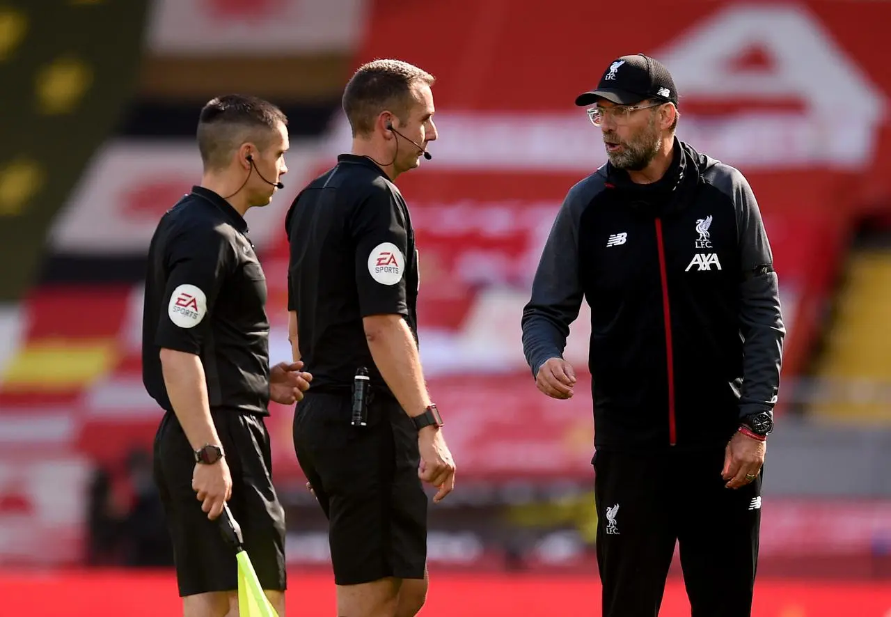 Former Liverpool head coach Jurgen Klopp speaks to referee David Coote