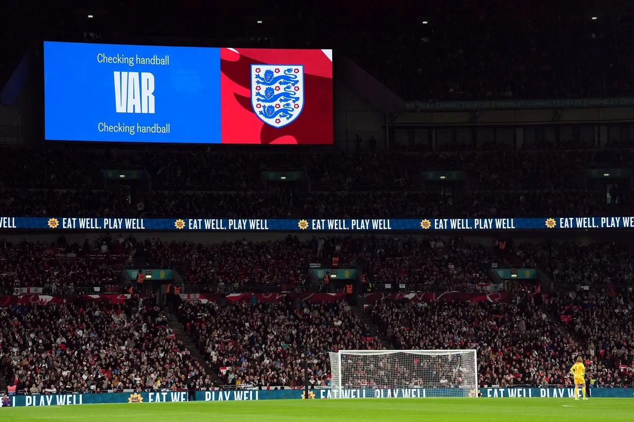 The big screen displays a VAR check for a handball against England’s Alex Greenwood