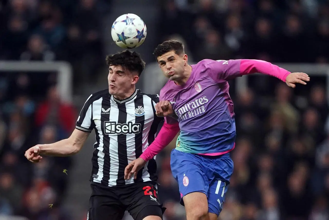 Newcastle United’s Tino Livramento and AC Milan’s Christian Pulisic (right) battle for the ball