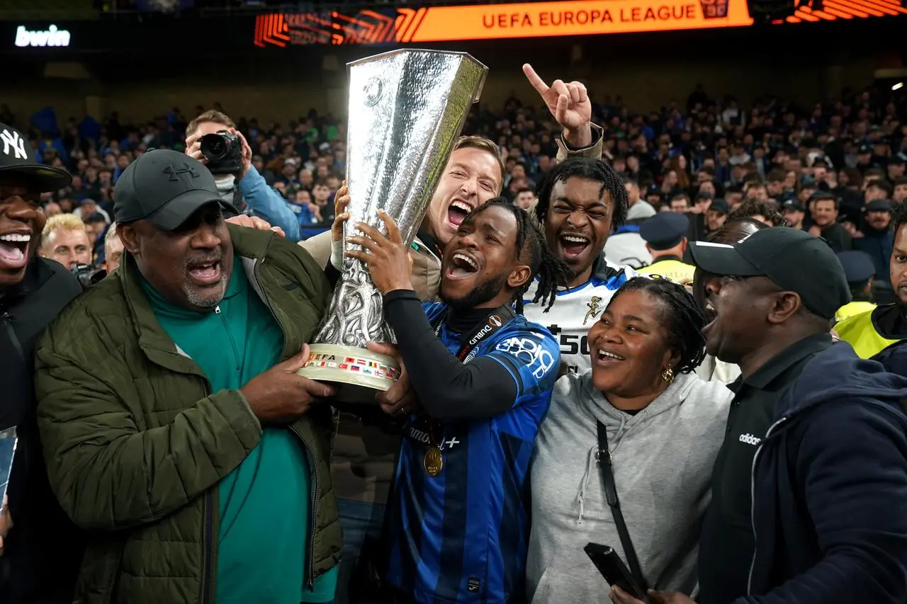 Ademola Lookman celebrates winning the Europa League with father Felix, left, and family members