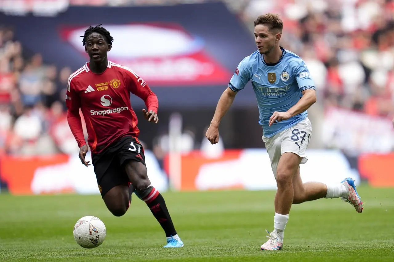 Manchester United’s Kobbie Mainoo (left) and Manchester City’s James McAtee