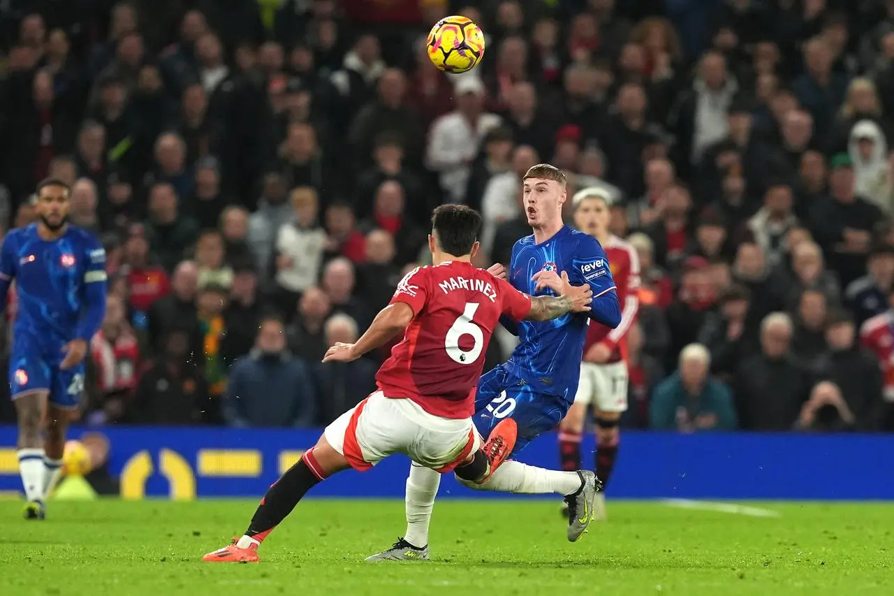 Lisandro Martinez tackles Cole Palmer in Mancheser United's clash with Chelsea