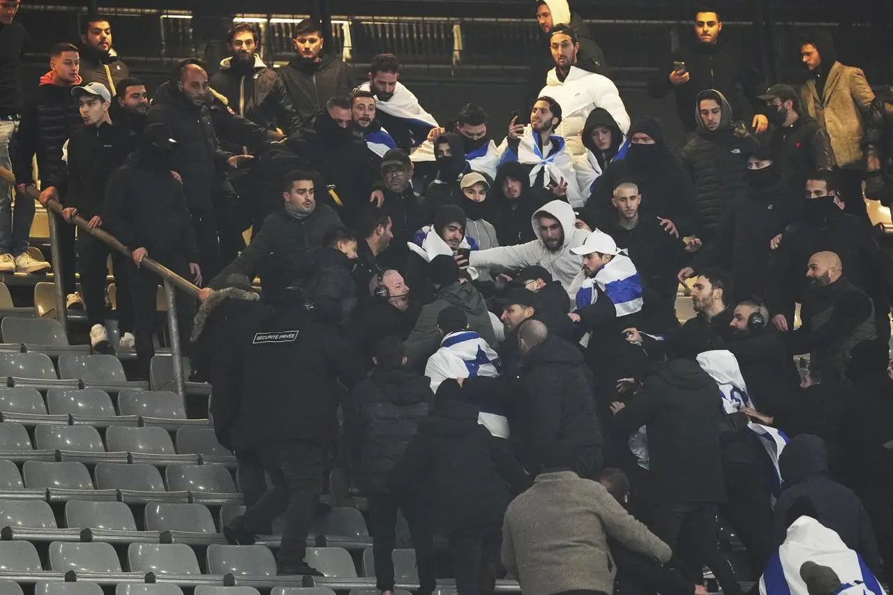 Fans clash in the stands during the Nations League match between France and Israel at the Stade de France