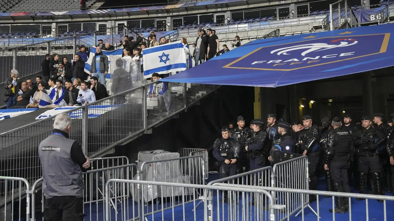 Police officers stand near the pitch ahead of the Nations League match between France and Israel in Paris 