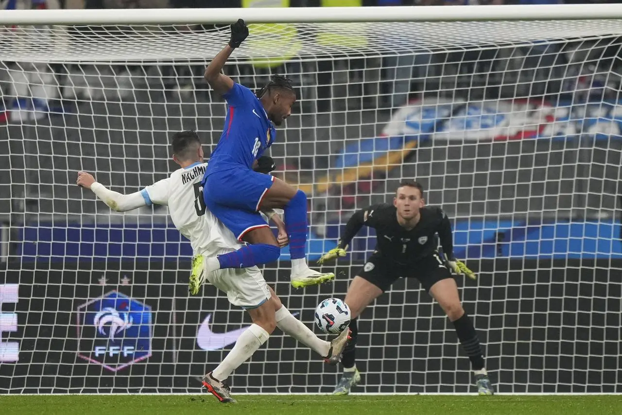 France’s Christopher Nkunku and Israel’s Idan Nachmias compete for the ball during a Nations League match