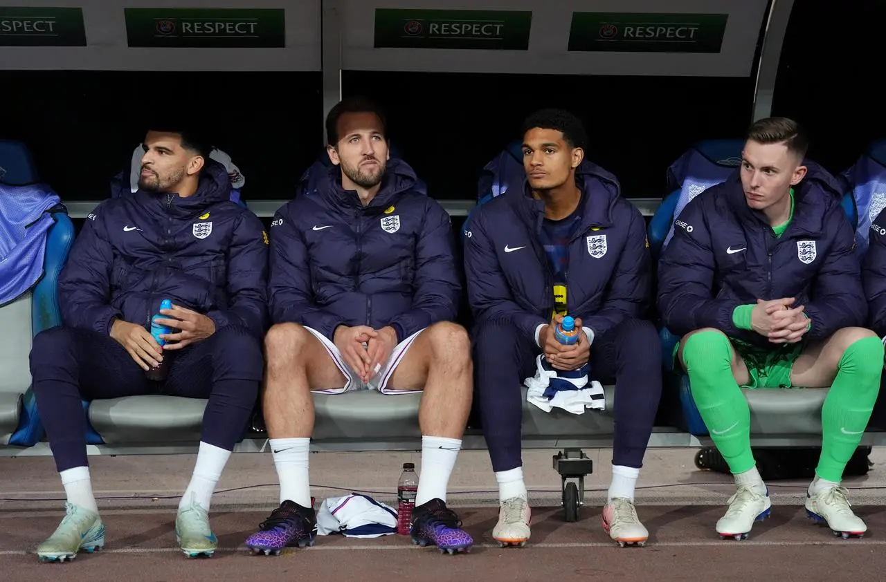 Harry Kane sits among the other England substitutes on the bench