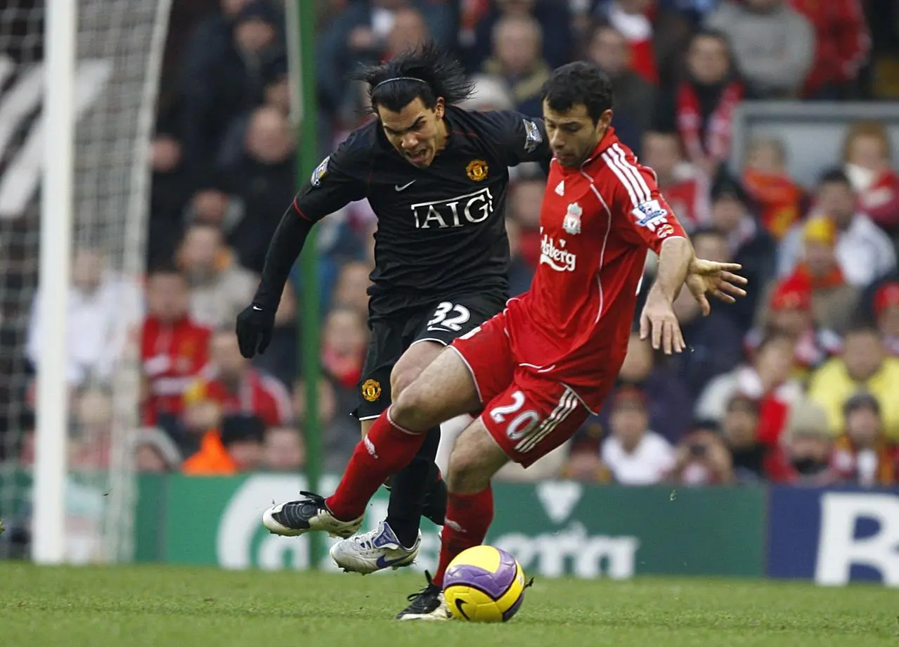 Carlos Tevez and Javier Mascherano battle for the ball