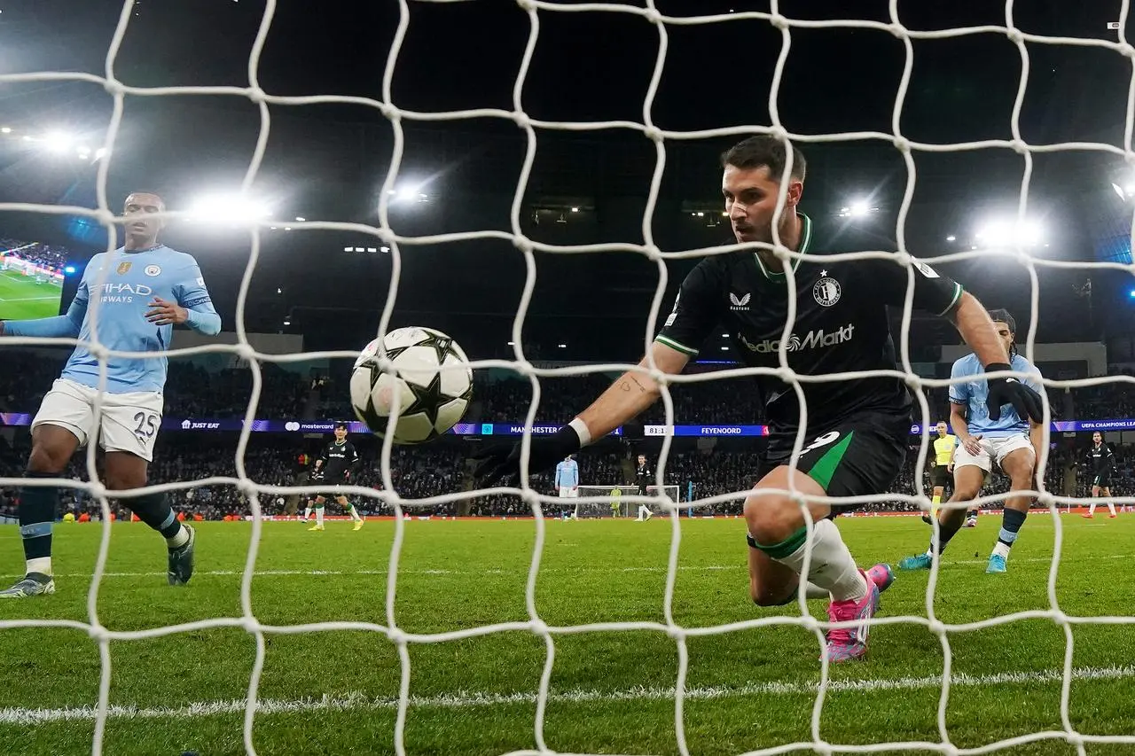 Santiago Gimenez, right, scores Feyenoord’s second goal against Manchester City with his chest from almost on the goal-line