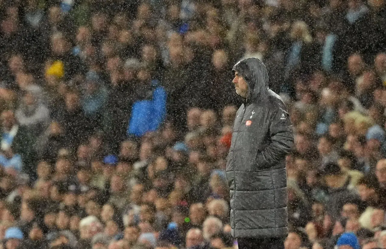 Tottenham manager Ange Postecoglou in the rain at the Etihad Stadium