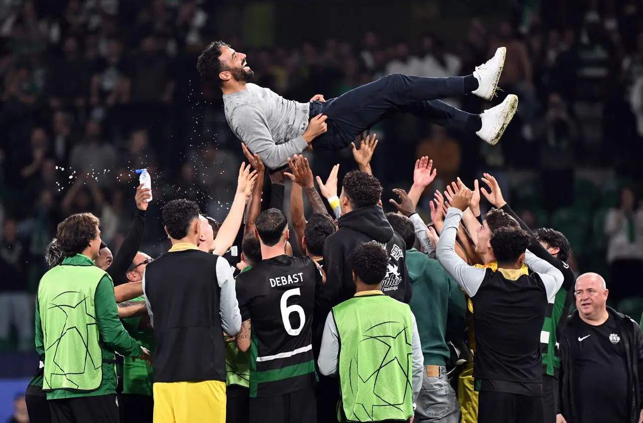 Sporting Lisbon manager Ruben Amorim is thrown into the air by his players as they celebrate beating Manchester City