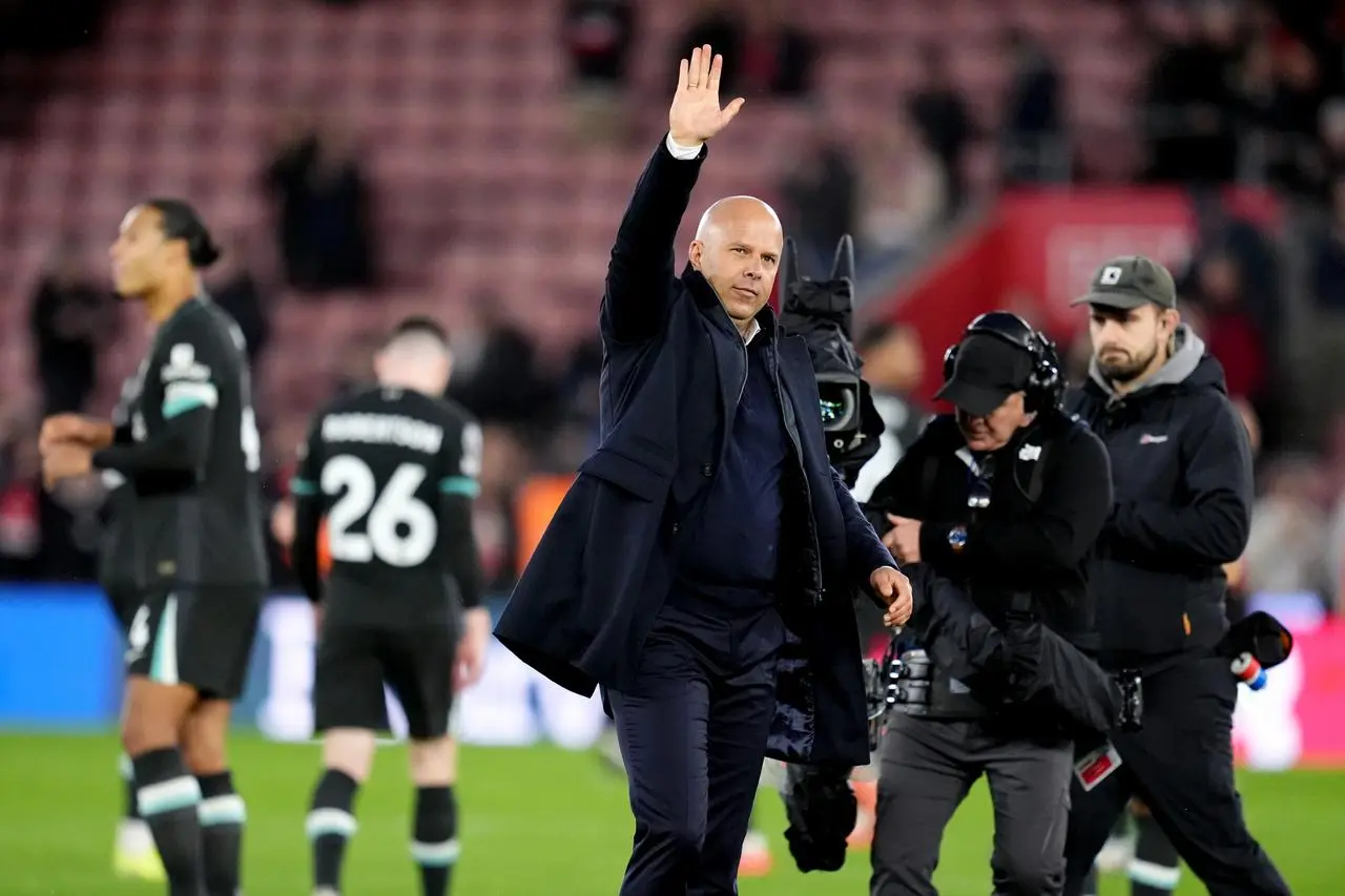 Arne Slot applauds the fans at the end of the match