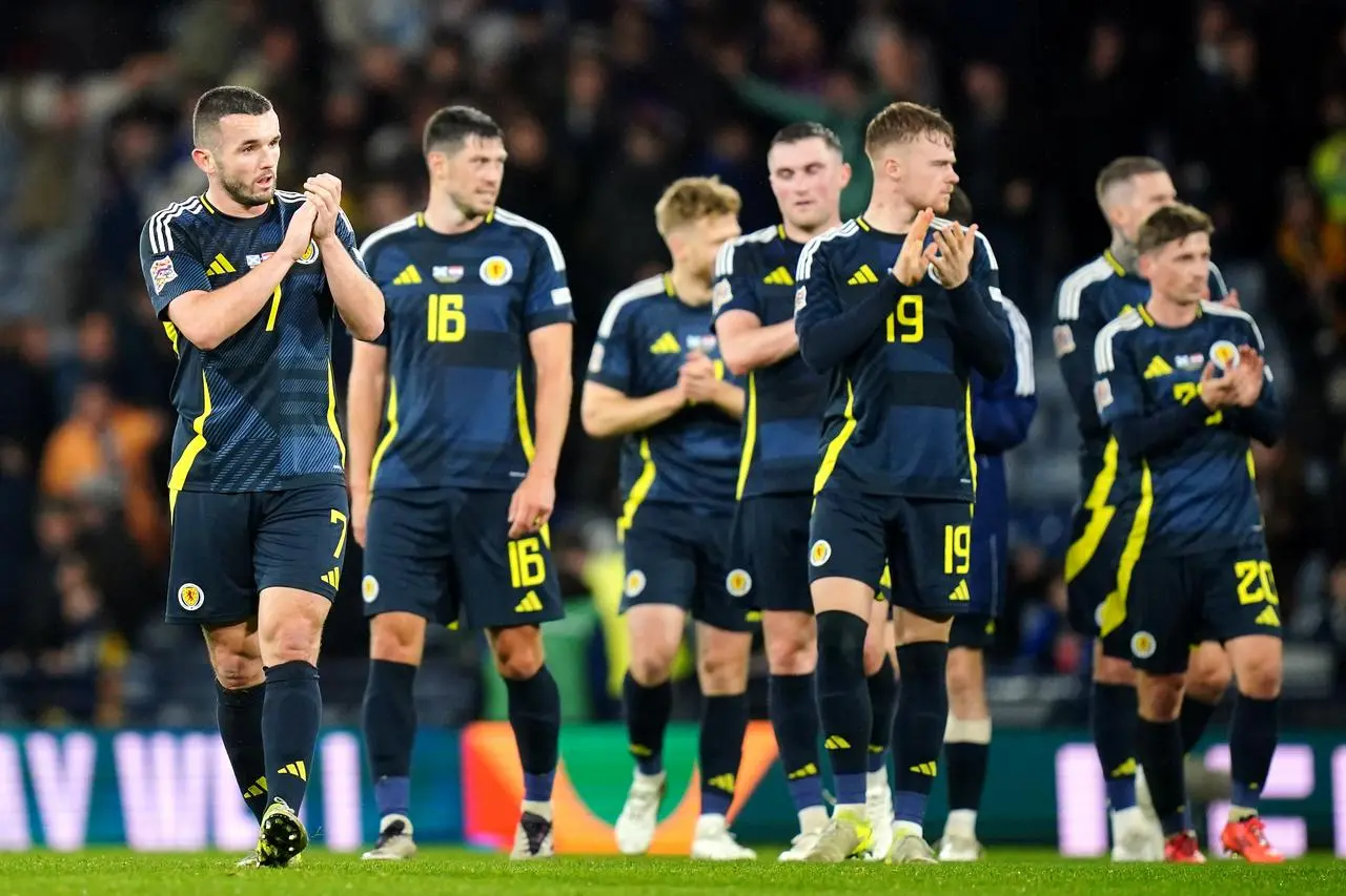 Scotland’s John McGinn (left) and team-mates applaud the fans