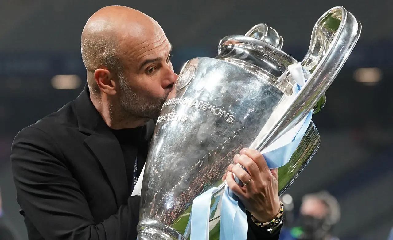 Pep Guardiola kisses the Champions League trophy