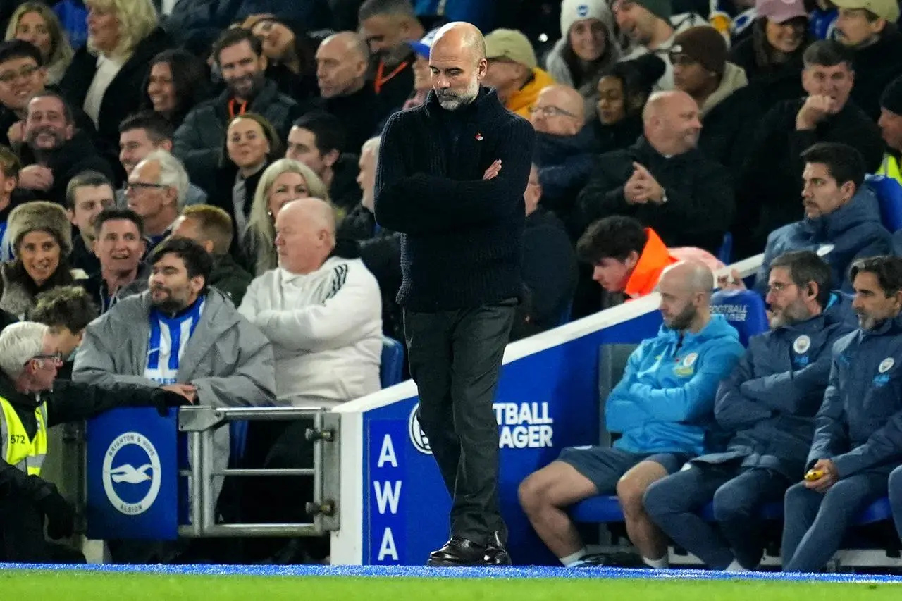 Manchester City manager Pep Guardiola looks to the ground during the loss at Brighton (Adam Davy/PA)