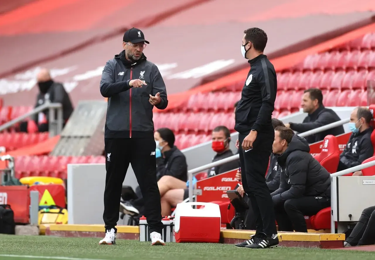 Jurgen Klopp (left) gestures towards fourth official David Coote during a Premier League match at Anfield