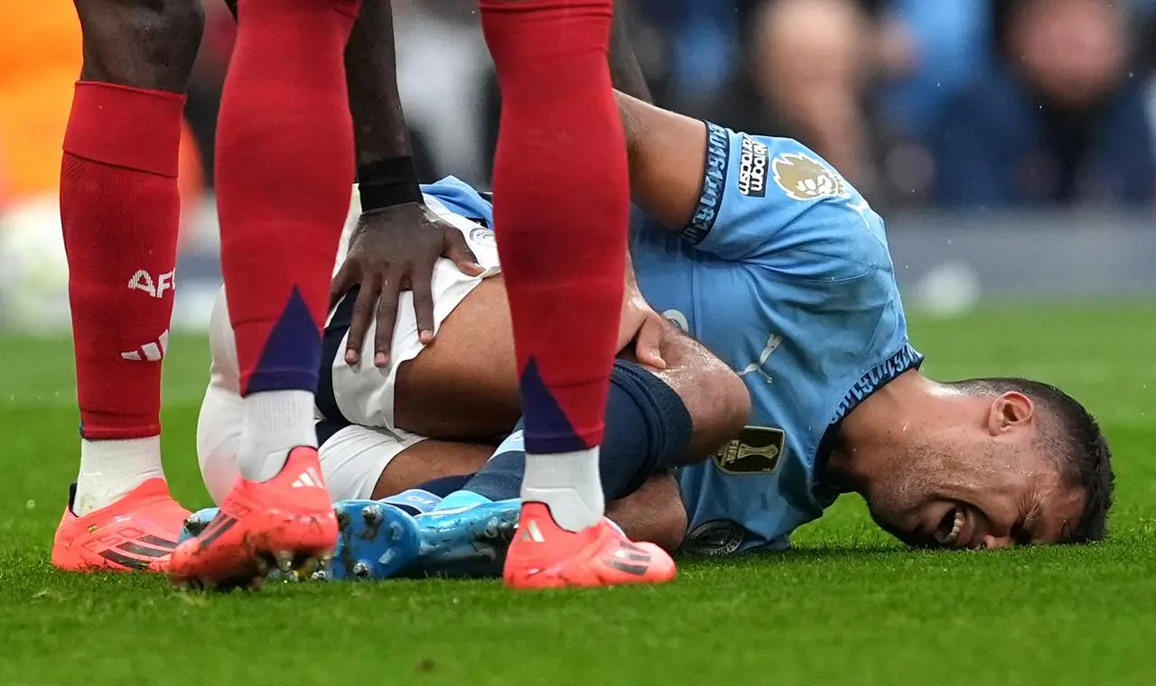 Rodri lies on the ground injured against Arsenal