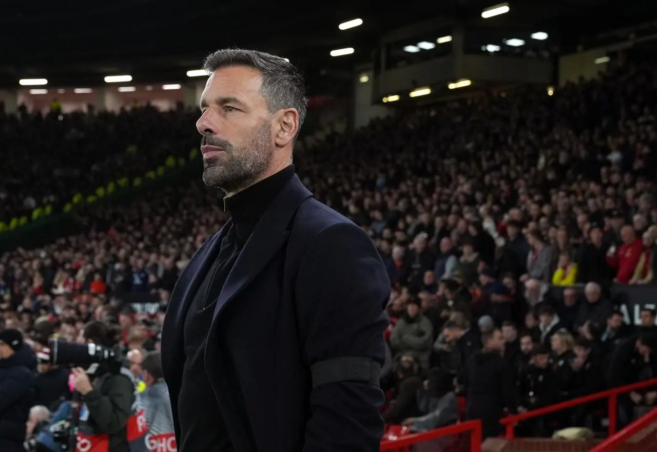 Ruud van Nistelrooy stands on the Old Trafford touchline