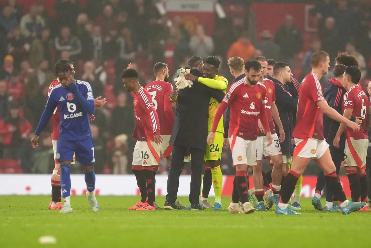 Manchester United interim manager Ruud van Nistelrooy embraces Andre Onana after his side's win over Leicester