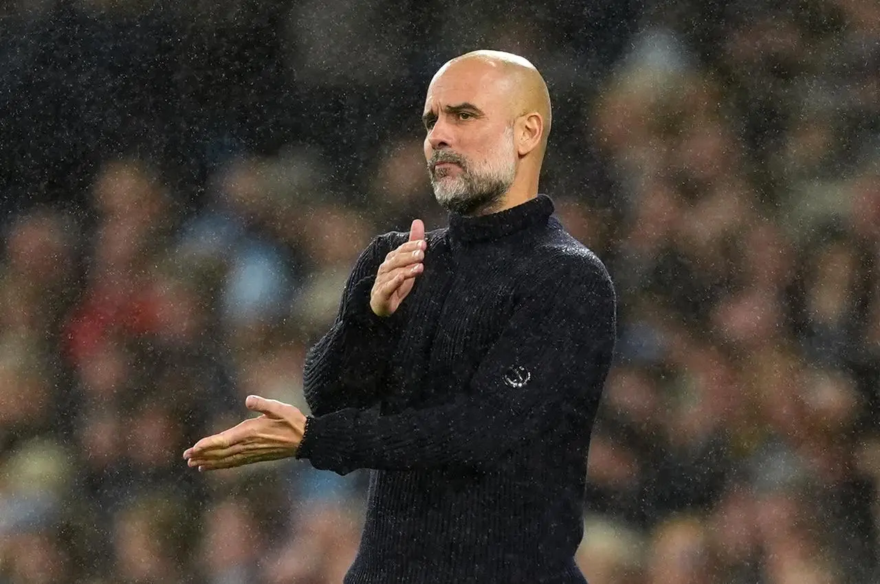 Pep Guardiola swipes one hand across the other in frustration during Manchester City's 4-0 defeat to Tottenham