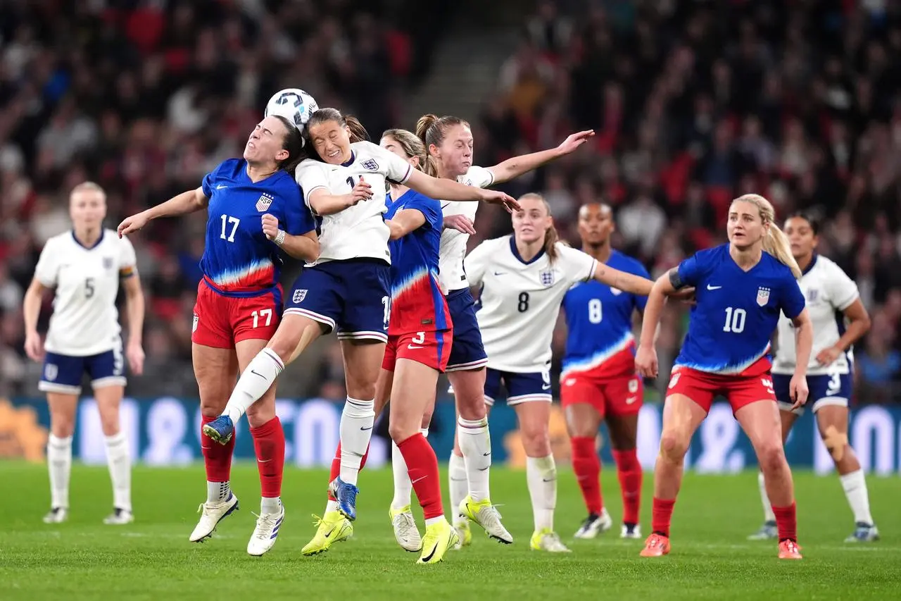 USA’s Sam Coffey and England’s Fran Kirby battle for the ball 