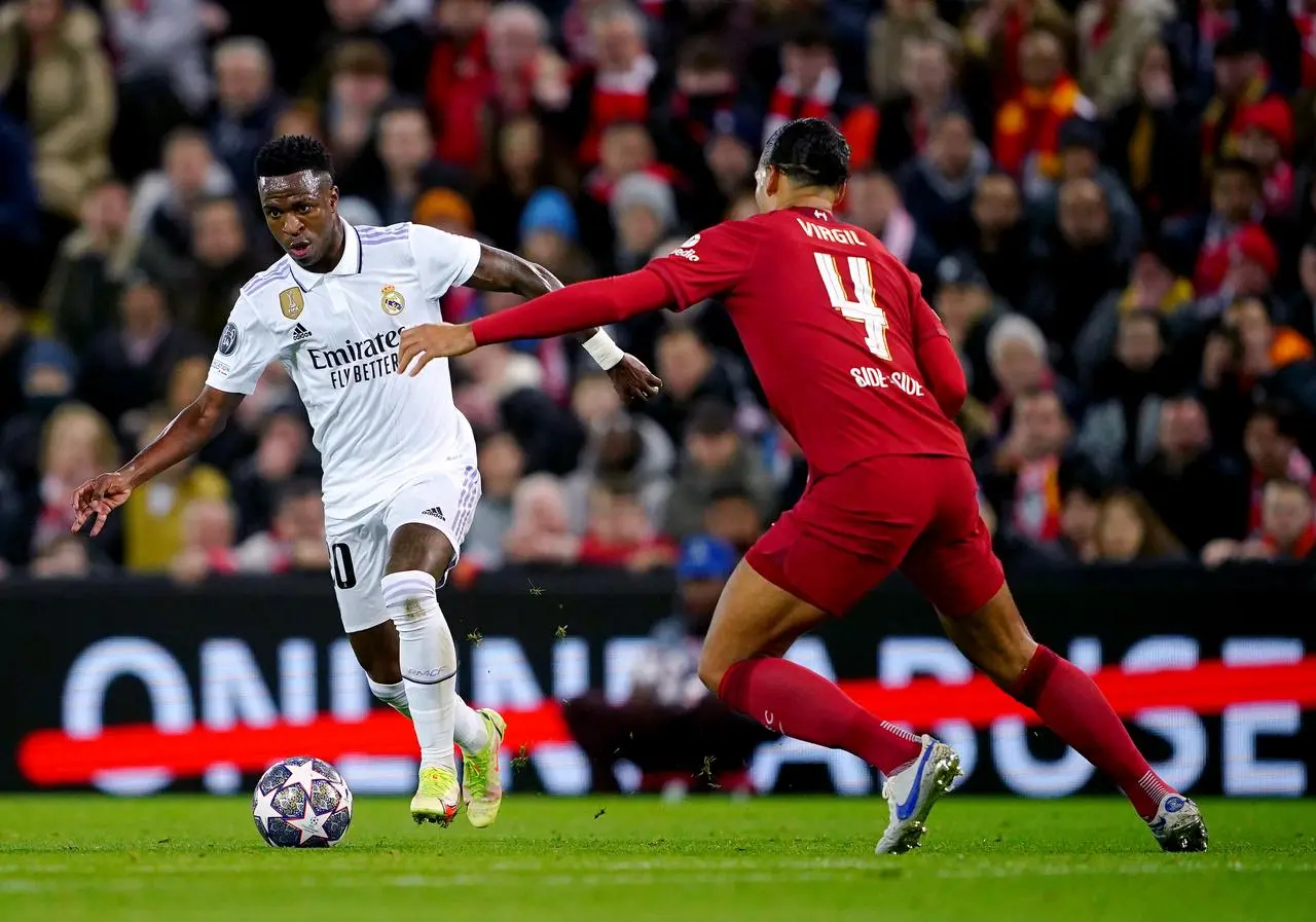 Real Madrid’s Vinicius Junior tries to dribble past Liverpool’s Virgil van Dijk