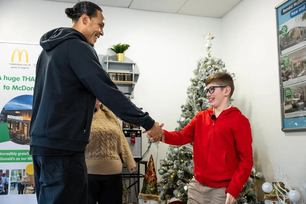 Virgil van Dijk shakes hands with 10-year-old Oliver Johnson